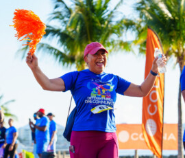 Lavaughn Fernander, Customer Service Manager at Colina, waves her pom-poms in excitement.