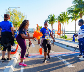 Colina's Communications Manager, Chantal A. Horton, motivates Sales Representative, Sandra Smith, to cross the finish line.