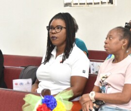 Maxine V. Seymour, director of corporate communications at Colina, looks on during the ceremony.