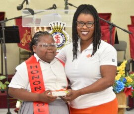 Maxine V. Seymour, director of corporate communications at Colina, honors Kaliah Taylor for her hard work throughout the school year.