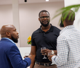Colleagues engage in conversation at the grand opening.