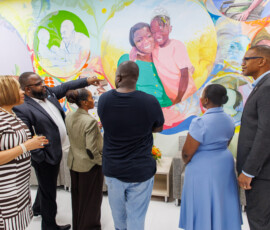 Attendees admire Allan Pachino Wallace’s mural at the Southwest location.