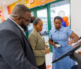 DeAndrea Lewis demonstrates how to use the kiosk.